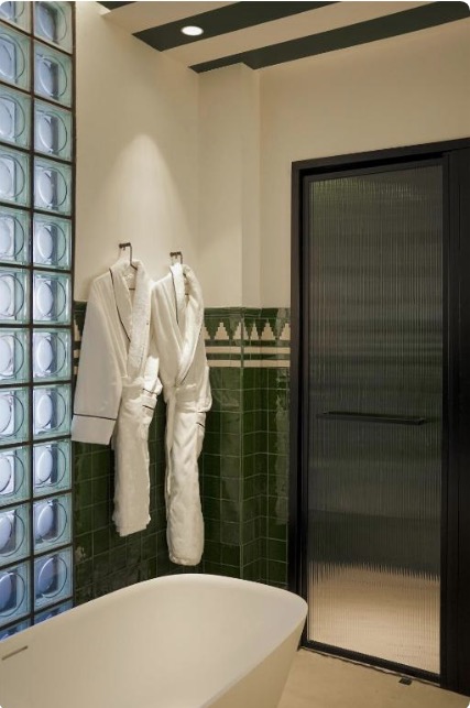 Baño con azulejo verde en Thompson Sevilla